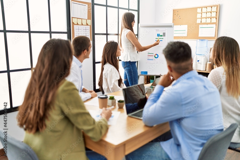 Group of business workers on chart board presentation at the office. Group of business workers on chart board presentation at the office.