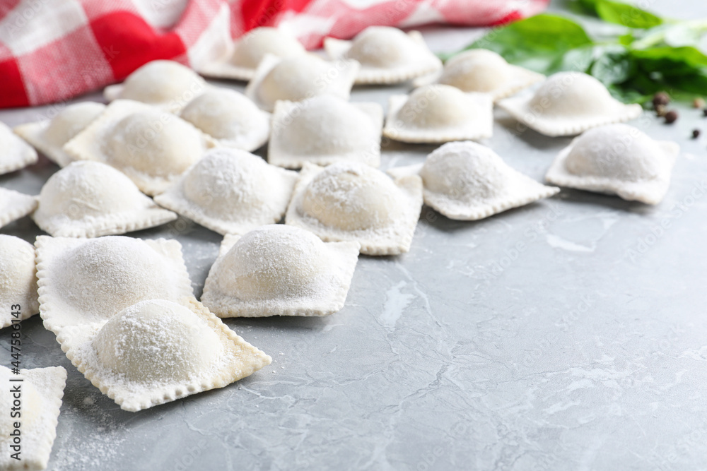 Uncooked ravioli on grey marble table, closeup. Space for text Uncooked ravioli on grey marble table, closeup. Space for text