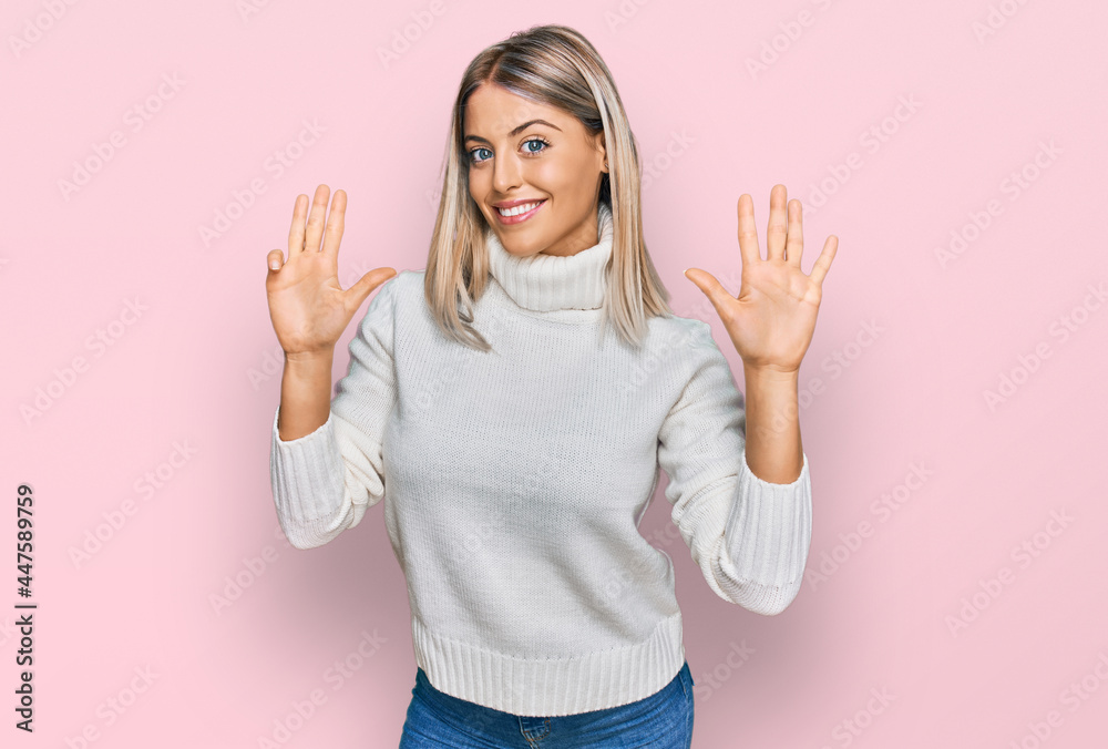 Beautiful blonde woman wearing casual turtleneck sweater showing and pointing up with fingers number nine while smiling confident and happy. Beautiful blonde woman wearing casual turtleneck sweater showing and pointing up with fingers number nine while smiling confident and happy.