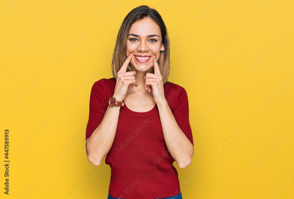 Young blonde girl wearing casual clothes smiling with open mouth, fingers pointing and forcing cheerful smile Young blonde girl wearing casual clothes smiling with open mouth, fingers pointing and forcing cheerful smile