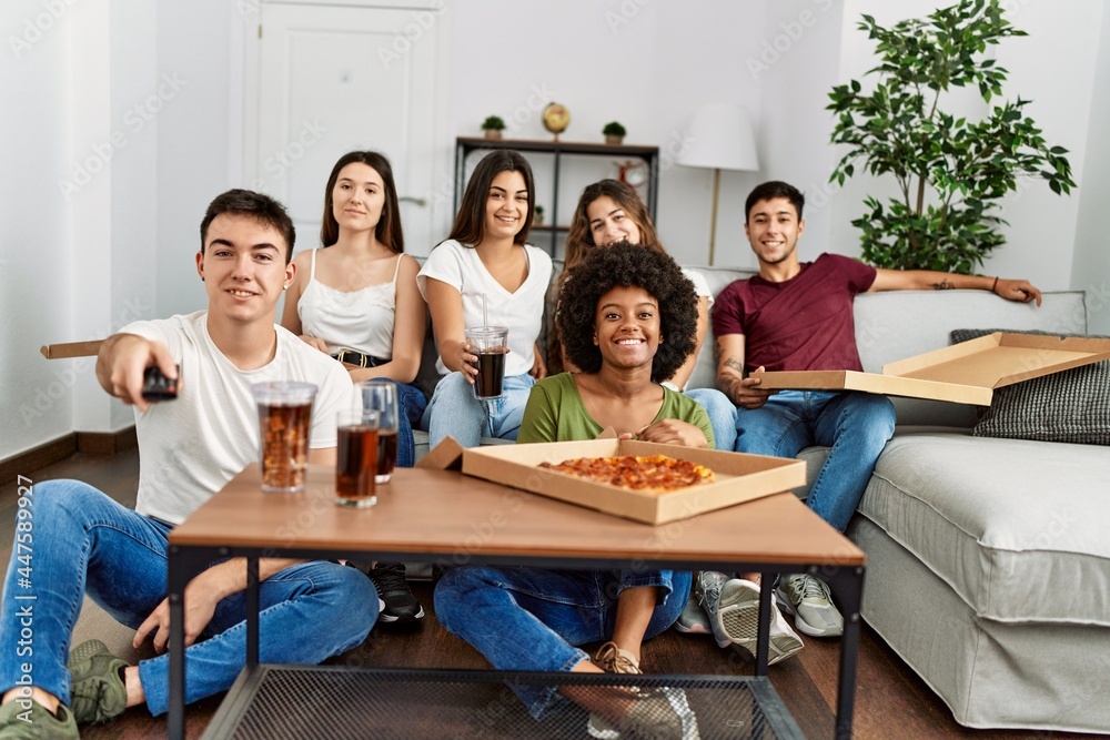 Group of young friends eating italian pizza and watching movie at home. Group of young friends eating italian pizza and watching movie at home.
