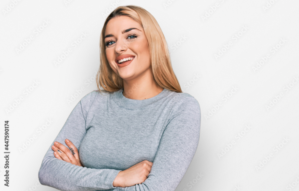 Young caucasian woman wearing casual clothes happy face smiling with crossed arms looking at the camera. positive person. Young caucasian woman wearing casual clothes happy face smiling with crossed arms looking at the camera. positive person.