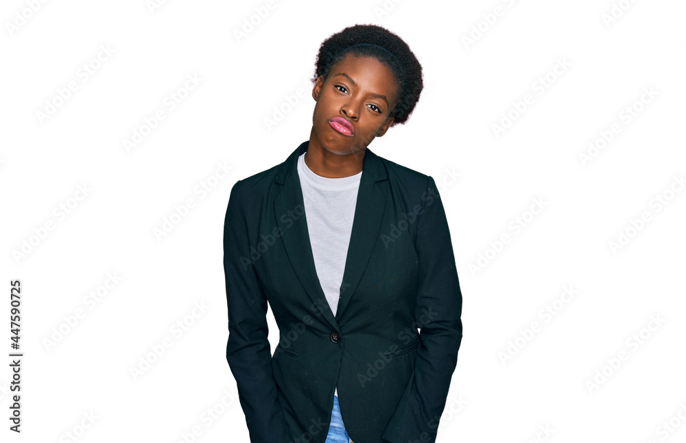 Young african american girl wearing business clothes looking at the camera blowing a kiss on air being lovely and sexy. love expression. Young african american girl wearing business clothes looking at the camera blowing a kiss on air being lovely and sexy. love expression.