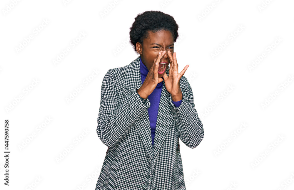 Young african american girl wearing casual clothes shouting angry out loud with hands over mouth Young african american girl wearing casual clothes shouting angry out loud with hands over mouth