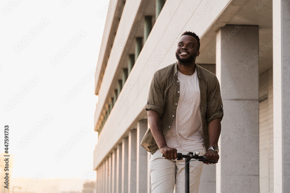 Young african american man using electric scooter outdoor in the city - Focus on face Young african american man using electric scooter outdoor in the city - Focus on face