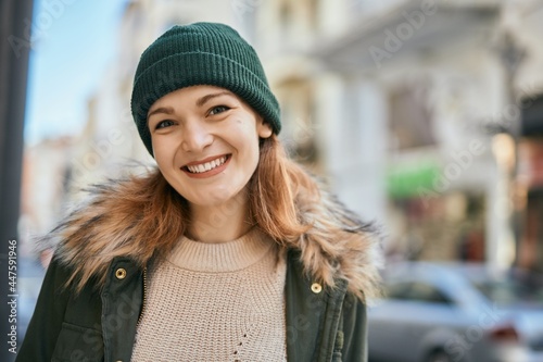 Young caucasian girl smiling happy standing at the city.