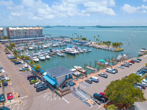 Gulf of Mexico Florida. Sailboat, yacht, boat dock. Aerial view of dock. Boats moored by the pier. Parking lot for cars. Ocean blue-green saltwater. Summer vacations. Dunedin FL USA. photo