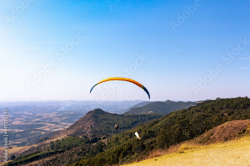 paragliding flying over mountains of the city of Poços de Caldas, Brazil
