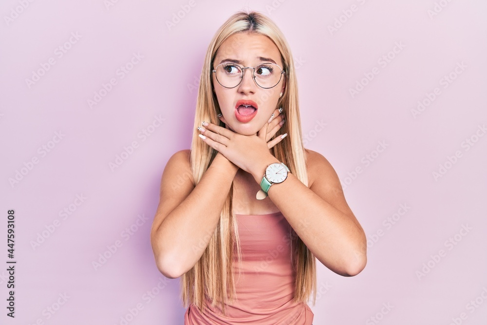 Young blonde girl wearing casual clothes shouting suffocate because painful strangle. health problem. asphyxiate and suicide concept. Young blonde girl wearing casual clothes shouting suffocate because painful strangle. health problem. asphyxiate and suicide concept.