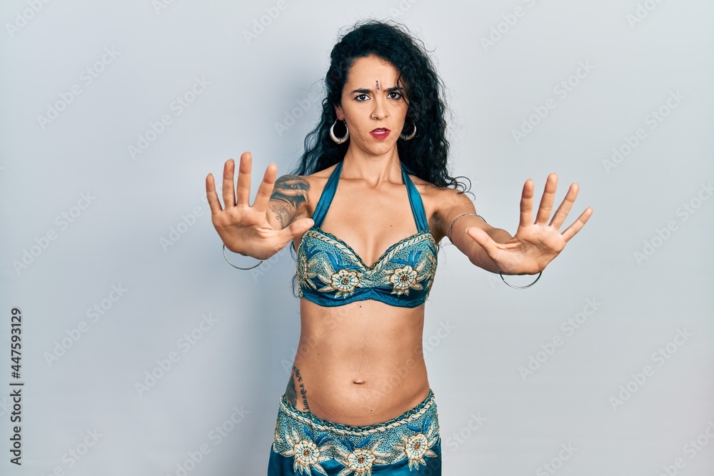 Young woman wearing bindi and traditional belly dance clothes doing stop gesture with hands palms, angry and frustration expression Young woman wearing bindi and traditional belly dance clothes doing stop gesture with hands palms, angry and frustration expression