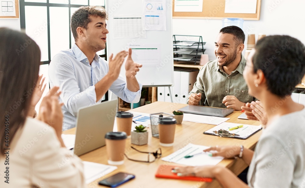 Group of business workers smiling and clapping to partner at the office. Group of business workers smiling and clapping to partner at the office.