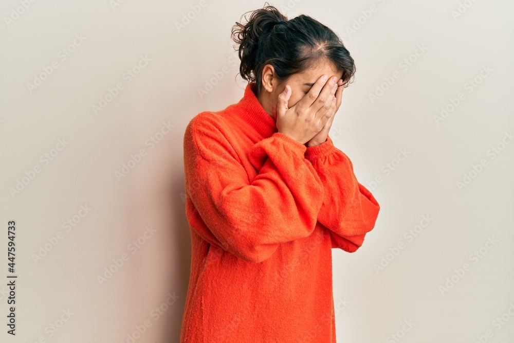 Young hispanic woman wearing casual winter sweater with sad expression covering face with hands while crying. depression concept. Young hispanic woman wearing casual winter sweater with sad expression covering face with hands while crying. depression concept.