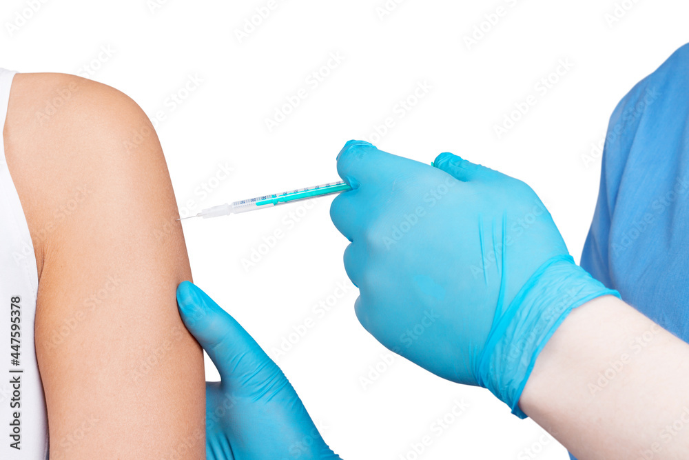 Doctor gives a syringe with vaccine to patient at clinic. Doctor gives a syringe with vaccine to patient at clinic.