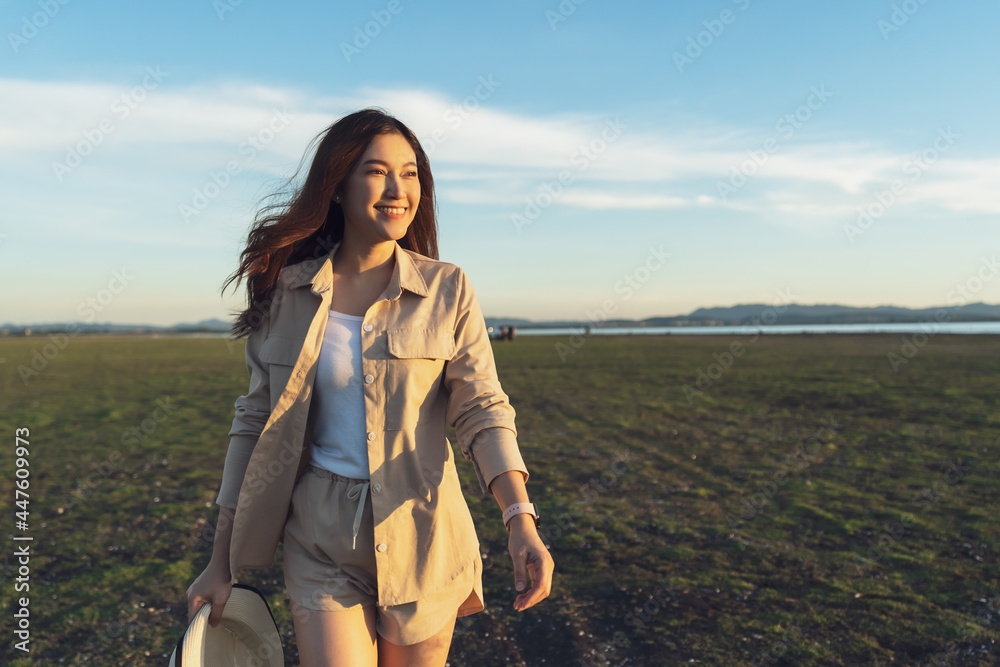 cheerful woman walk across the field with sunlight cheerful woman walk across the field with sunlight