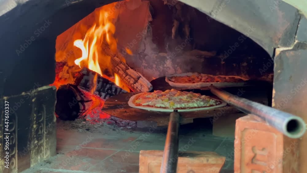 hot pizza in charcoal oven with fire
hot pizza in charcoal oven with fire