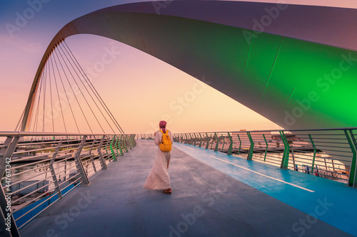 Photography Woman tourist walks on the tolerance suspension bridge in Dubai