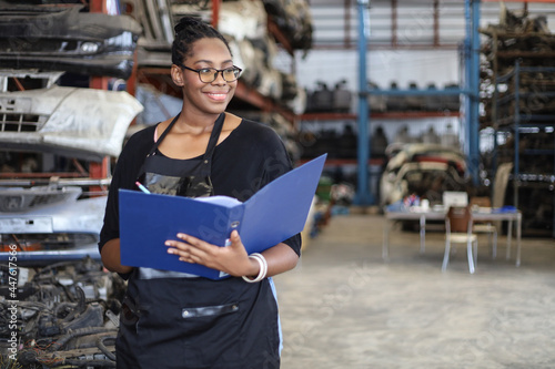 Businessman using laptop computer working or checking stock in warehouse factory, entrepreneurship or business owner concept