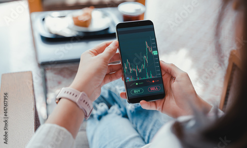 Business woman using smartphone with cryptocurrency money link network concept.Woman using mobile phone investing application. Stock market investment and trading cryptocurrency on app in hand. photo