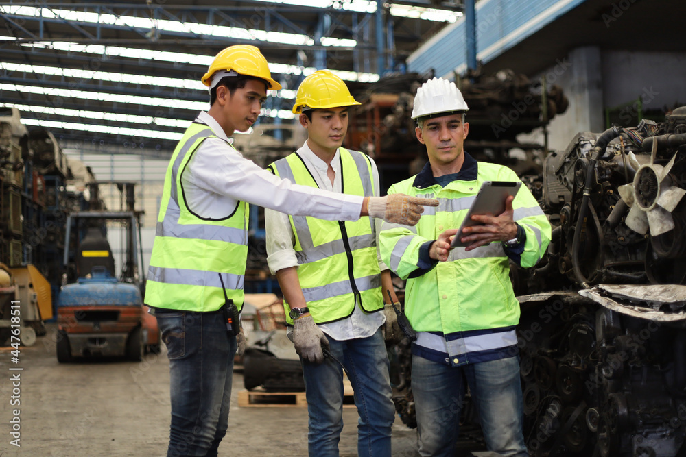 Worker or Engineer work in factory and talk with team by radio, Check stock and inspection in machine spare part engine warehouse Worker or Engineer work in factory and talk with team by radio, Check stock and inspection in machine spare part engine warehouse