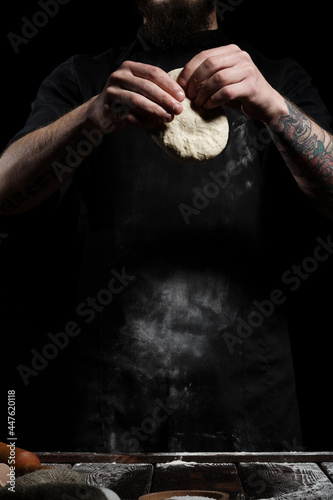 Chef knead fresh dough in hands