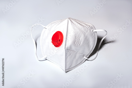 Disposable respirator made of non-woven materials. Protection class N99 FFP3  with valve. Personal protection against viruses and coronavirus infection COVID-19. photo