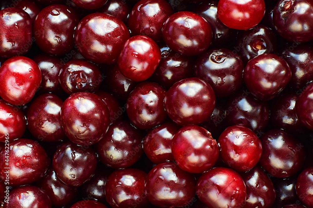 Ripe cherry berries with water drops as texture and background. Selective focus. Ripe cherry berries with water drops as texture and background. Selective focus.