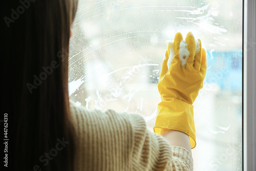 Woman in yellow rubber glov...