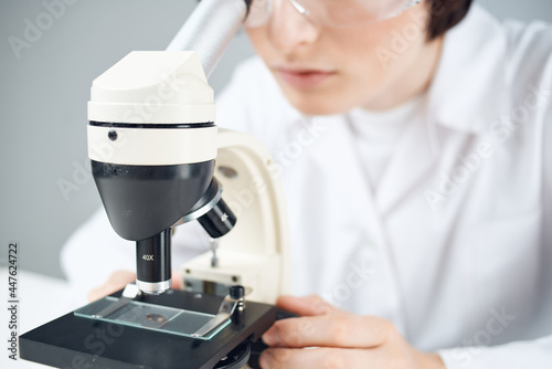 laboratory assistant looking microscope science research microbiology