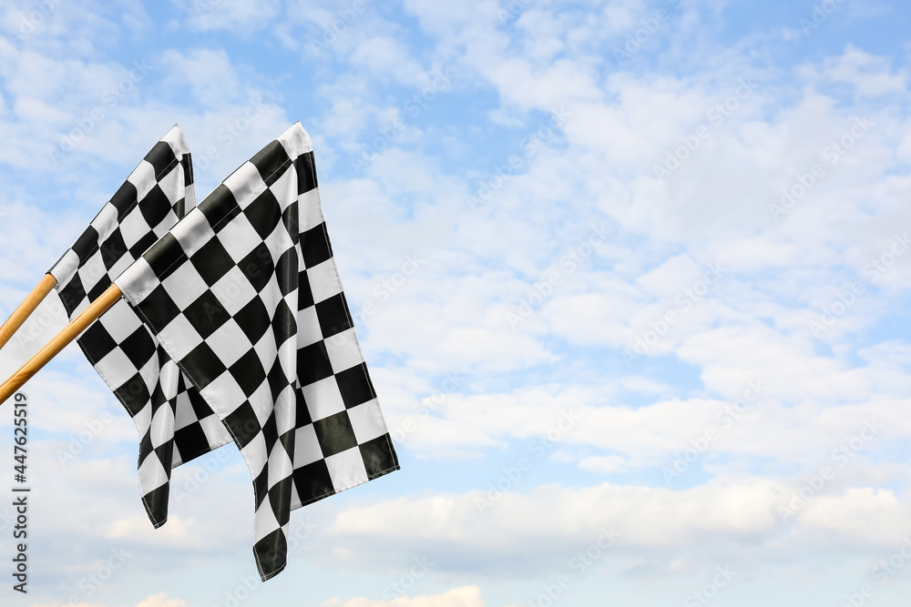 Racing flags against blue sky