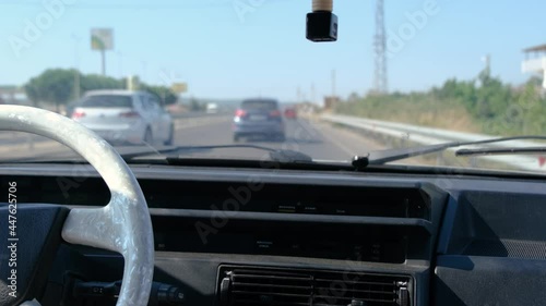 traveling on the highway in an old vehicle. man driving through traffic.