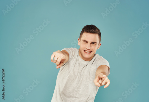cheerful handsome man gesturing with hands emotions lifestyle blue background