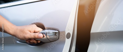 Man opening and closing his car to check the locking system
