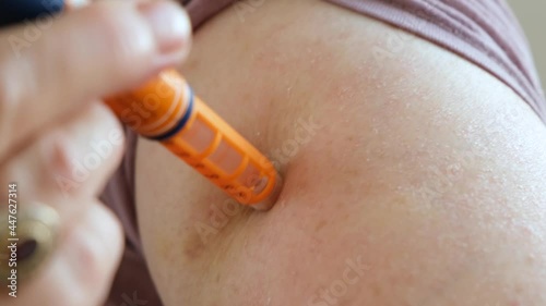 old woman with diabetes injects medicine into her arm with a needle. Insulin medication therapy for diabetes patients.
