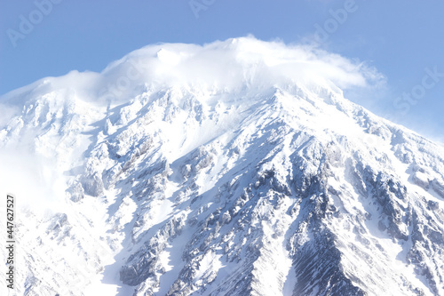 Russia, Natural Park "volcanoes of Kamchatka". The koryaksky volcano covered with snow and clouds on its rocks. The perfect weather for climbing. interesting and affordable for the tourists