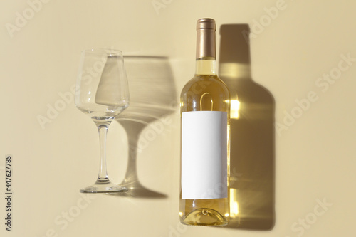 Bottle of exquisite wine and glass on color background © Pixel-Shot