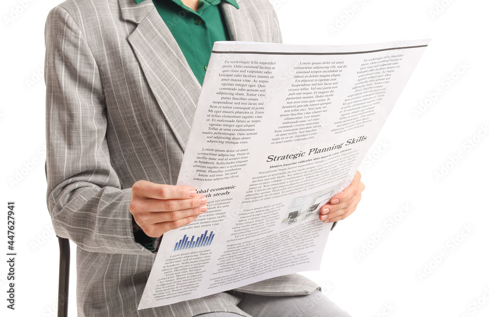 Naklejka premium Young businesswoman reading newspaper on white background