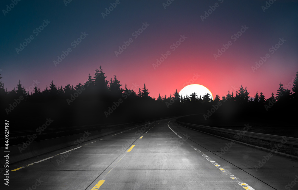 dark night road through forest and sky with red moon