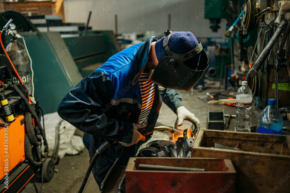 Welder working with electrode at semi-automatic arc welding. Welder working with electrode at semi-automatic arc welding.