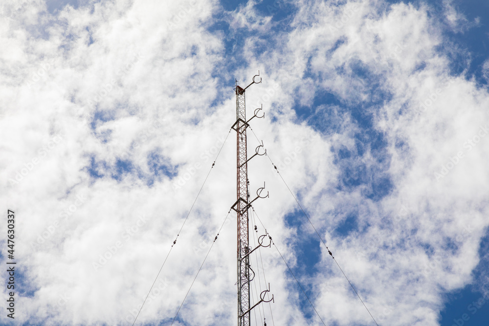 radio transmission towers in the city behind the bright sky radio transmission towers in the city behind the bright sky