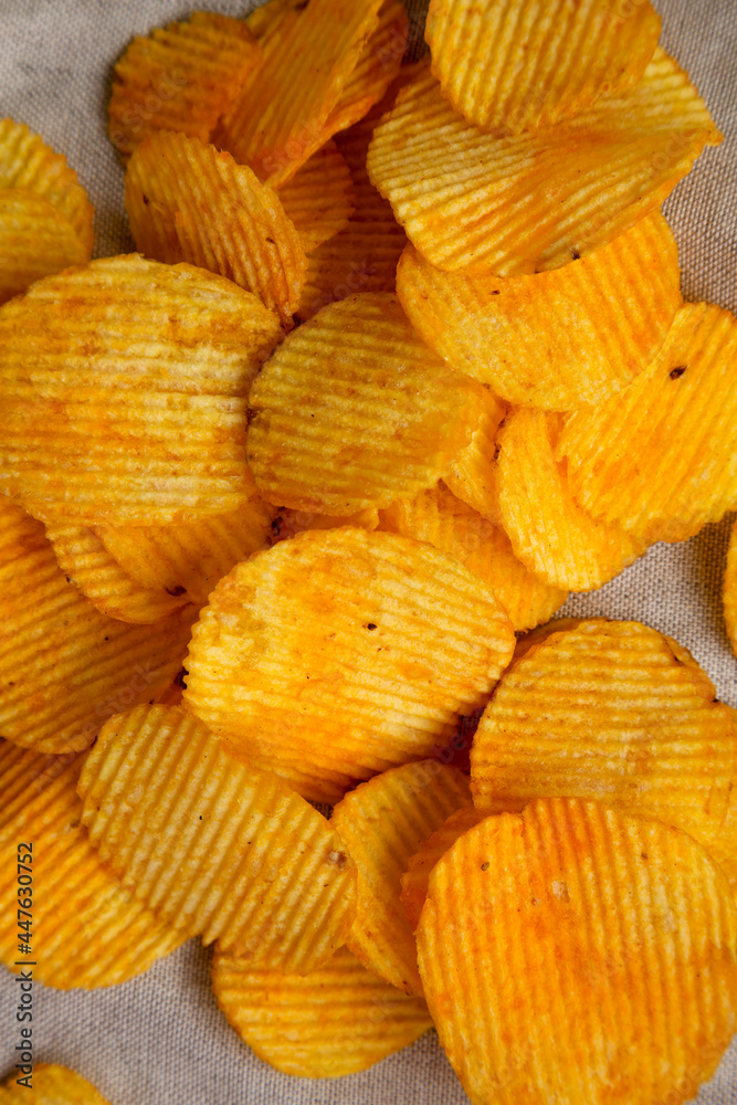 Ruffled Cheese Potato Chips, top view. Flat lay, overhead, from above. Ruffled Cheese Potato Chips, top view. Flat lay, overhead, from above.