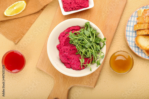 Composition with tasty beet hummus and sauces on color background