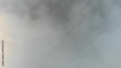 Aerial view of thick clouds over the old city, cinematic view from an aircraft