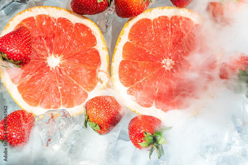 Grapefruit with strawberry in ice cube water Grapefruit with strawberry in ice cube water