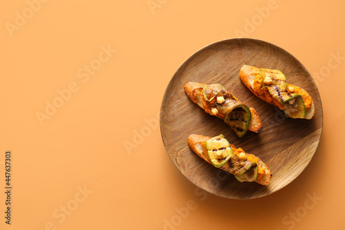 Tasty bruschettas with mushrooms on color background