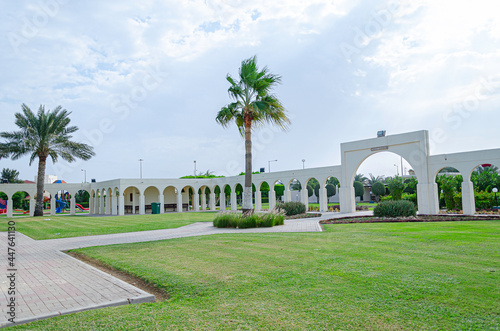 Lawn, arches and palms at Al Ruwais park in Qatar