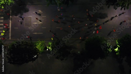 Aerial top shot of many runners running on the street at night of Ho Chi Minh City, Vietnam photo