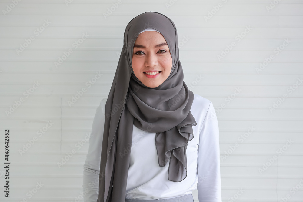 Portrait of cout beautiful Muslim woman wearing hijab traditional religious cloth posing with friendly looking to camera with a lovely smile on white background - obrazy, fototapety, plakaty 