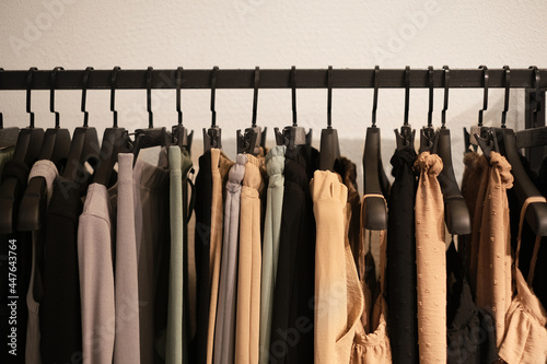 fashionable clothes made from natural fabrics on hangers in the store. new minimal collection of clothes in the boutique.