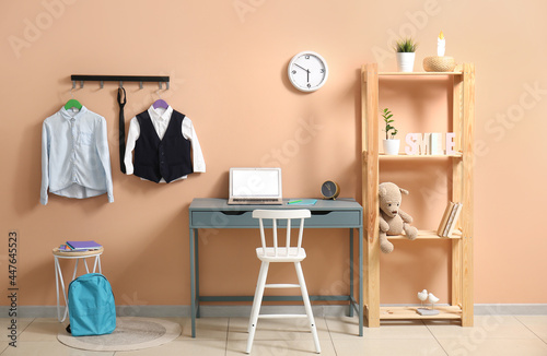 Interior of stylish room with modern workplace and school uniform © Pixel-Shot