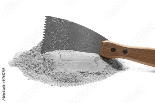 Spatula, trowel with gypsum, mortar pile isolated on white background photo